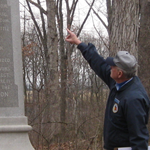 Richard Goedkoop pointing at the 28th Massachusetts Infantry Regiment monument